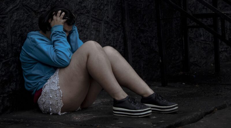 Girl holding her head while feeling stressed, representing mental health challenges and effective stress management.
